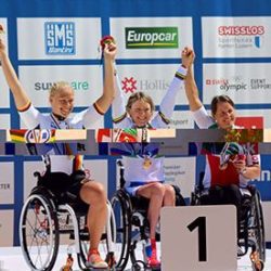 A group of women in wheelchairs on a podium.