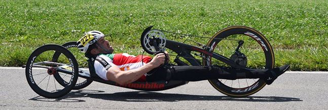 A boy riding a hand cycle at a high speed