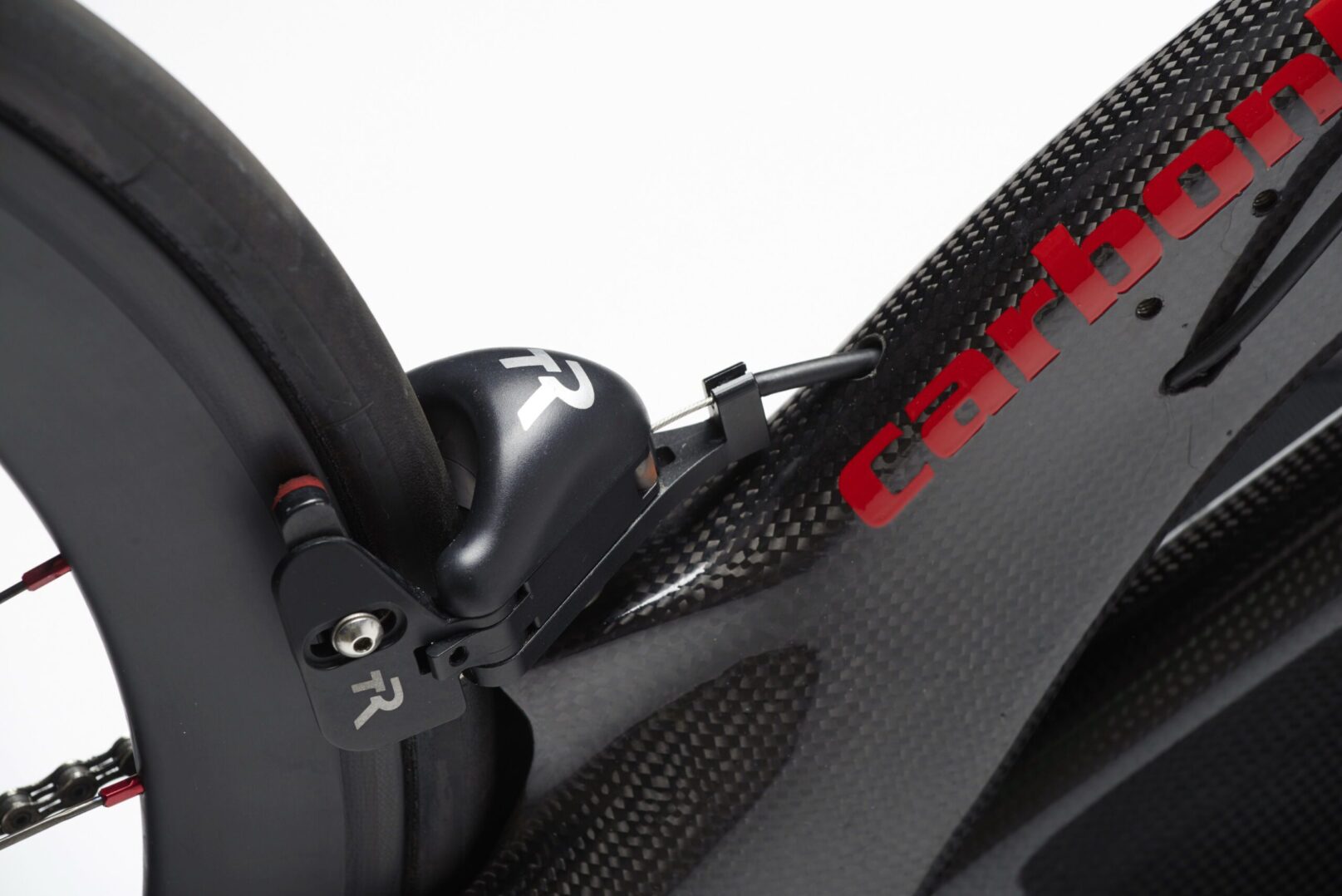 A close up of a carbon bike with a brake.