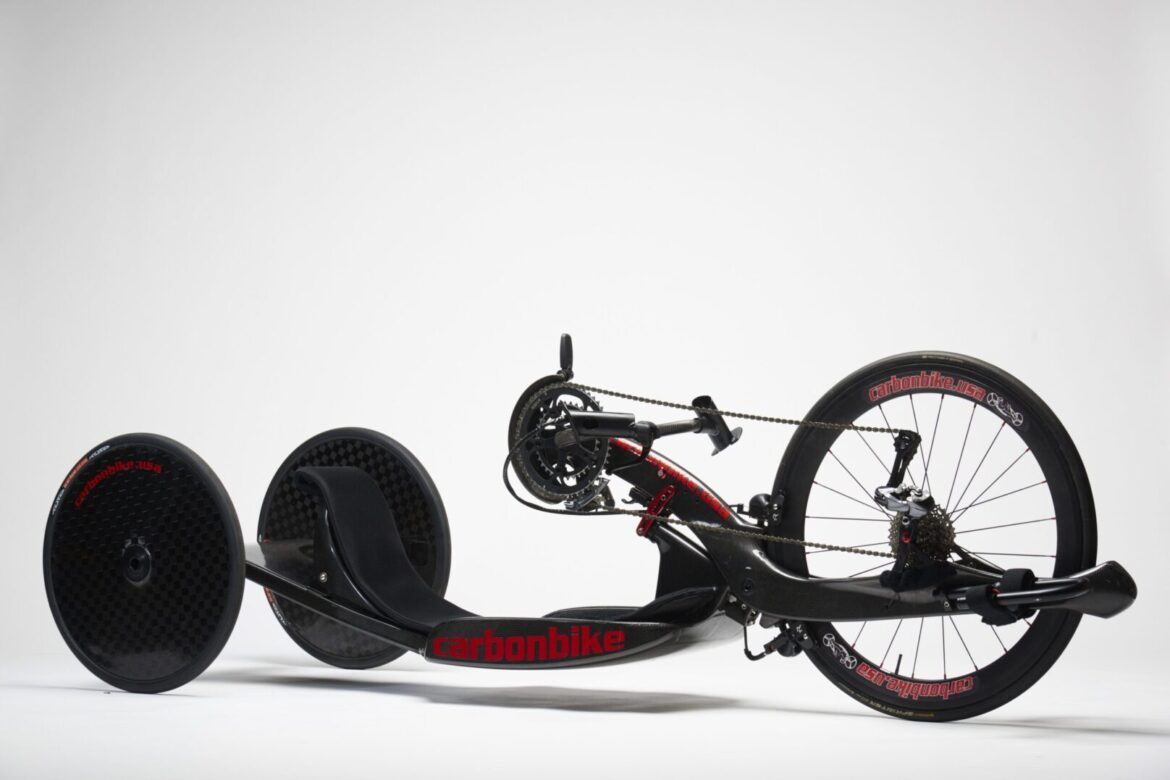 A black and red tricycle on a white background.