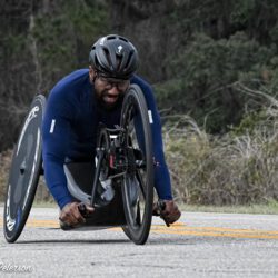 A man in a wheelchair on a road.