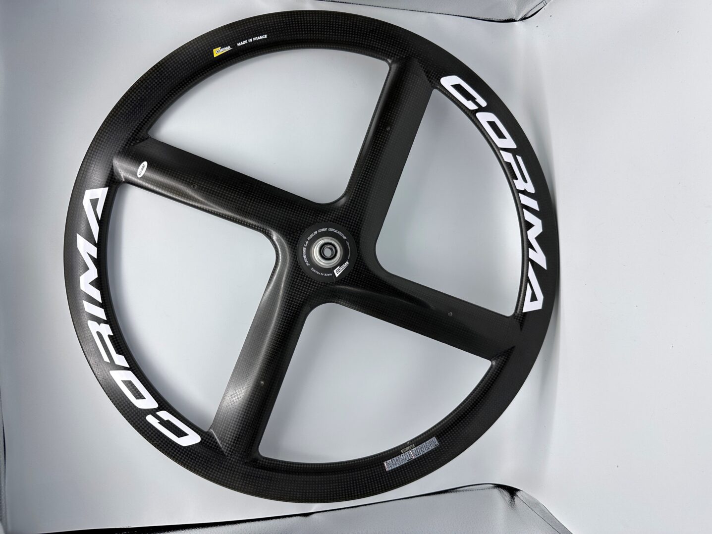 A RW-Carbonbike 20" racing chair wheel in a box with a logo on it.