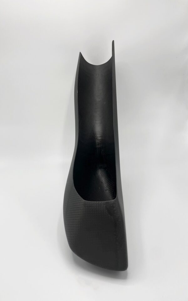 A black plastic H Carbon fiber foot rest on a white background.