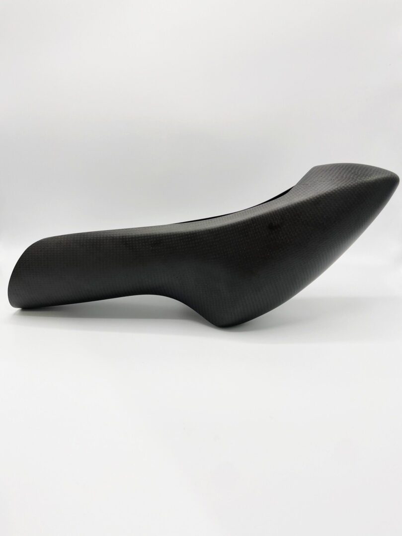 A black H Carbon fiber foot rests on a white background.