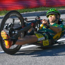 A man riding a hand cycle in high speed