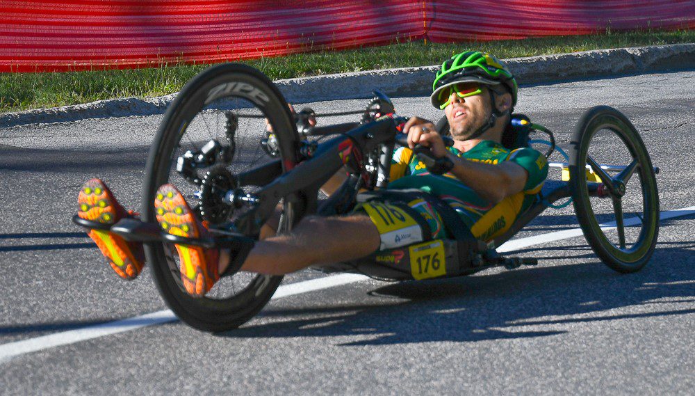 A man riding a hand cycle in high speed