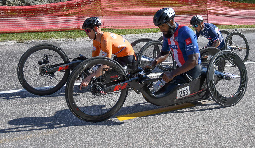 Some people riding with hand cycle on the track
