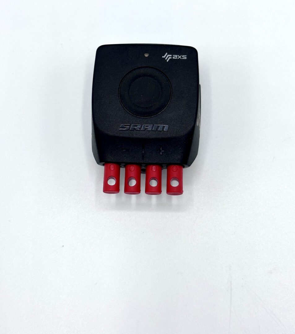 A small black H-Sram 12 speed Blip box with red buttons on it.