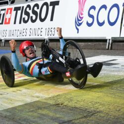A man in a wheelchair is celebrating after winning a race.